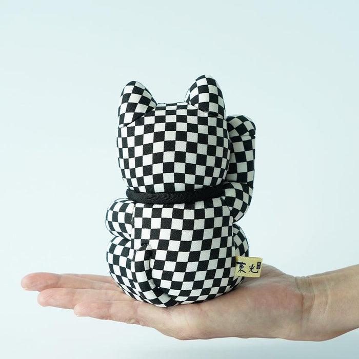 Black and white checkered maneki neko lucky cat doll held in hand | Edo art dolls, Kakinuma Dolls