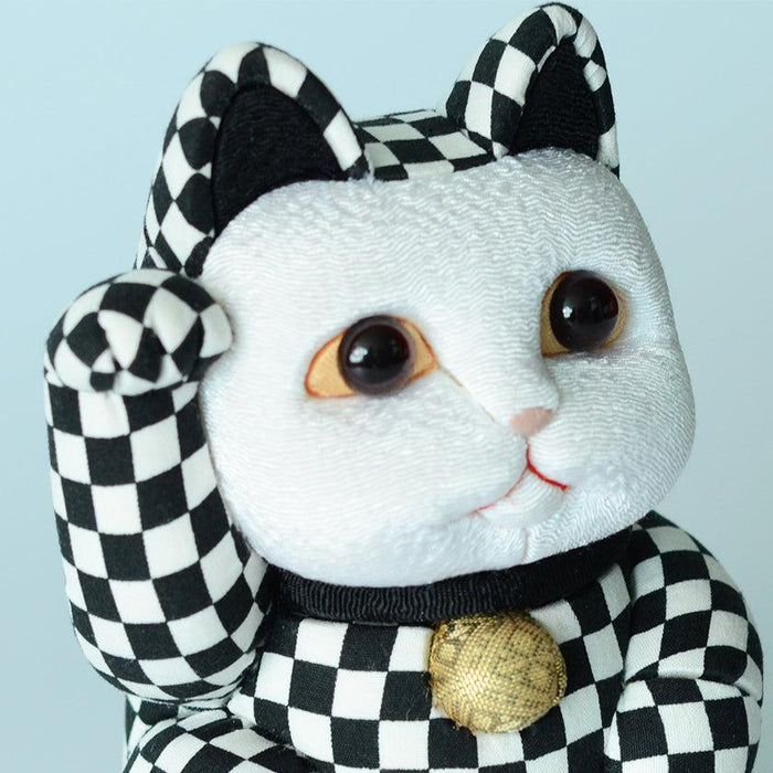Black and white checkered maneki neko lucky cat doll with raised paw and gold bell | Edo art dolls, Kakinuma Dolls
