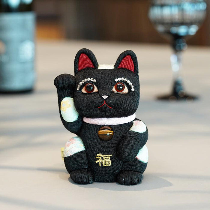 Black maneki neko lucky cat figurine with crystal lashes and floral accents | Edo art dolls, Kakinuma Dolls