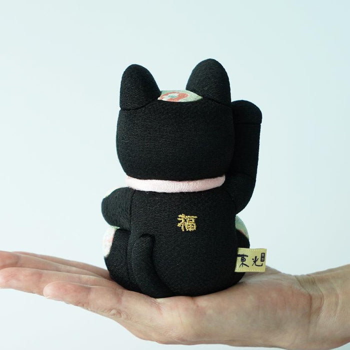 Black fabric maneki neko lucky cat doll held in hand, gold fuku embroidery | Edo art dolls, Kakinuma Dolls