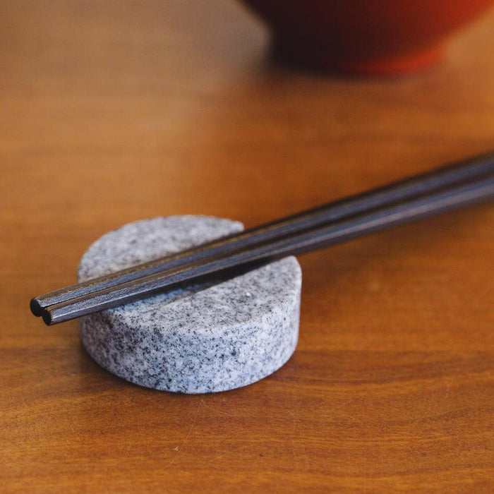 Aji stone chopstick rest holding dark chopsticks on wooden table | Kagawa, aeru
