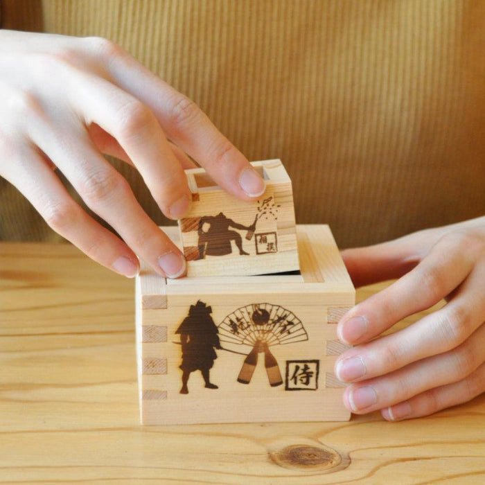 Wooden masu sake cup set with samurai engravings held in hands | woodworking, J.Flavor × Ohashi Japan