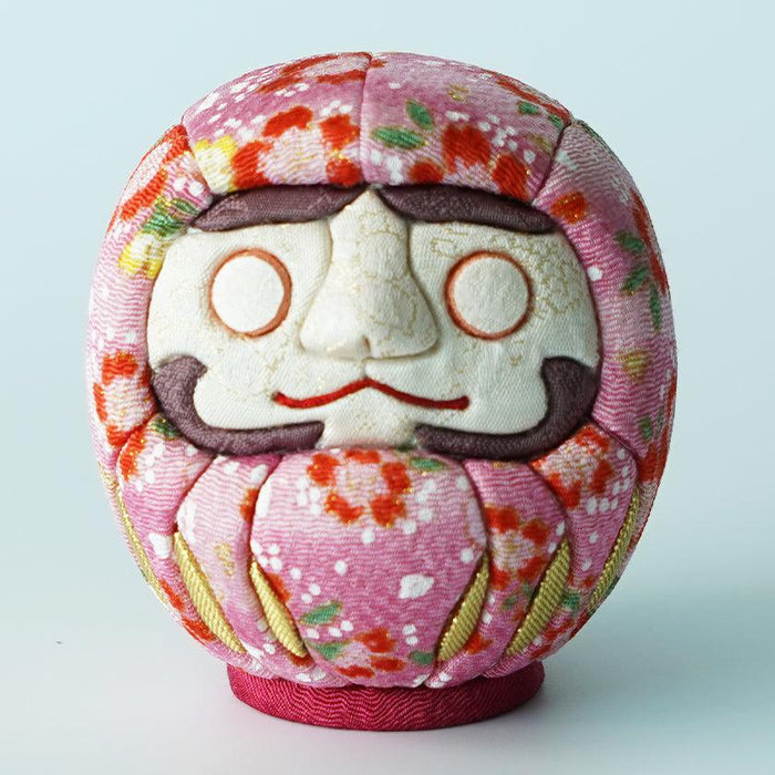 Pink chirimen fabric daruma doll with floral pattern, studio shot | Edo Art Dolls, Kakinuma Dolls