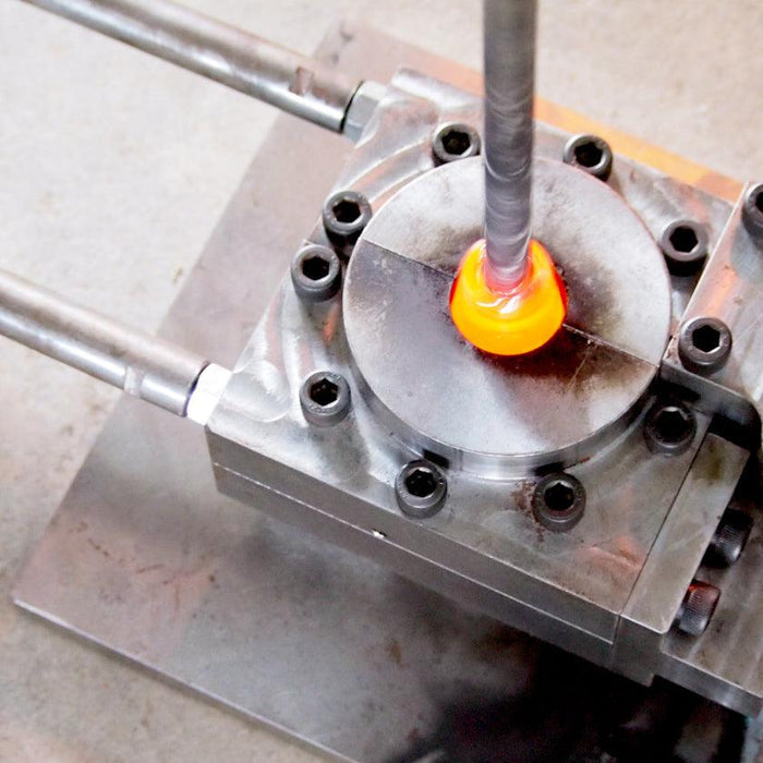 Molten glass being pressed into a steel mold during Ryukyu glassmaking process | Okinawa, aeru