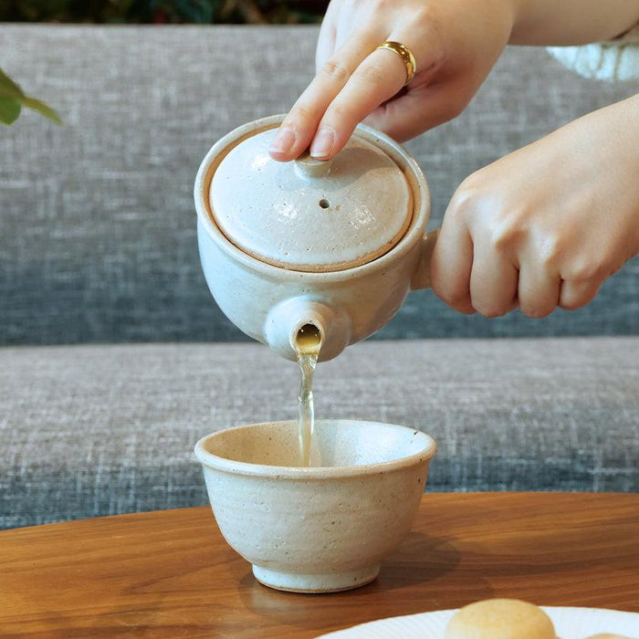 Pouring tea from a white Shigaraki ware kyusu teapot into a ceramic cup | Shigaraki, Yamasho Touki
