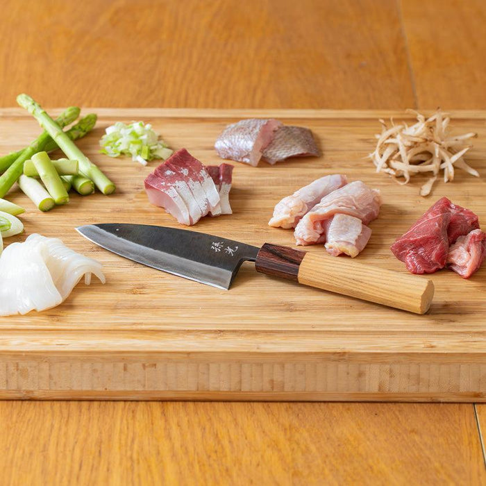Shinbu Deba knife 120mm on cutting board with fresh meat, fish, and vegetables | FUKUBE KAJI, Ishikawa