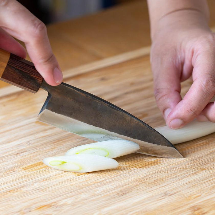 Shinbu Deba knife 120mm slicing green onion on wooden cutting board | FUKUBE KAJI, Ishikawa