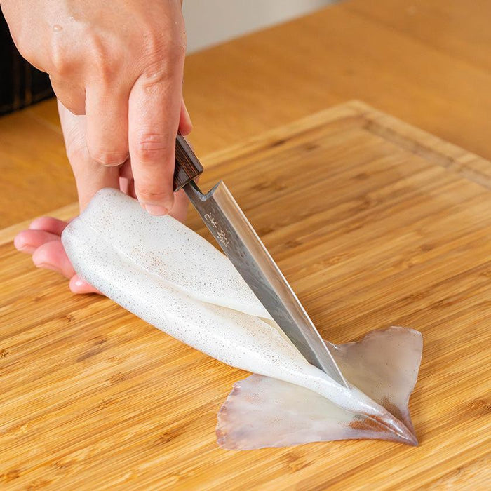 Deba knife slicing fresh squid on a wooden cutting board | Ishikawa, Fukube Kaji