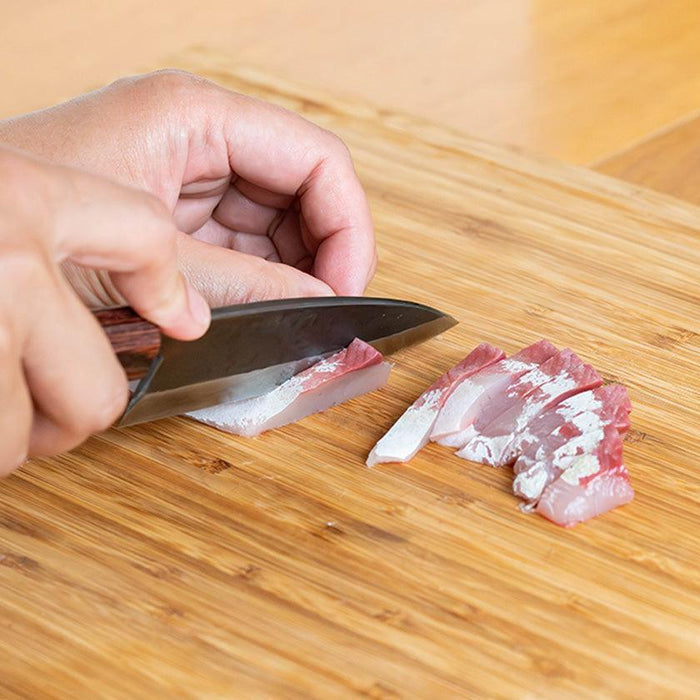 Shinbu deba knife 120mm slicing raw fish on a wooden cutting board | Fukube Kaji, Ishikawa