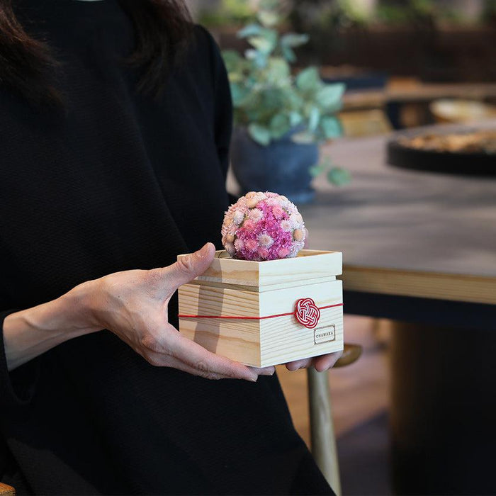 Preserved flower mari ball diffuser in a wooden box with mizuhiki knot, held in hands | CHAWAKA Kyoto Uji