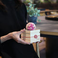 Preserved flower mari ball diffuser in a wooden box with mizuhiki knot, held in hands | CHAWAKA Kyoto Uji
