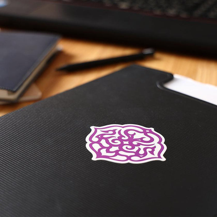 Ainu pattern sticker with purple arabesque design on black notebook | Hokkaido, CIKARPE AKAN