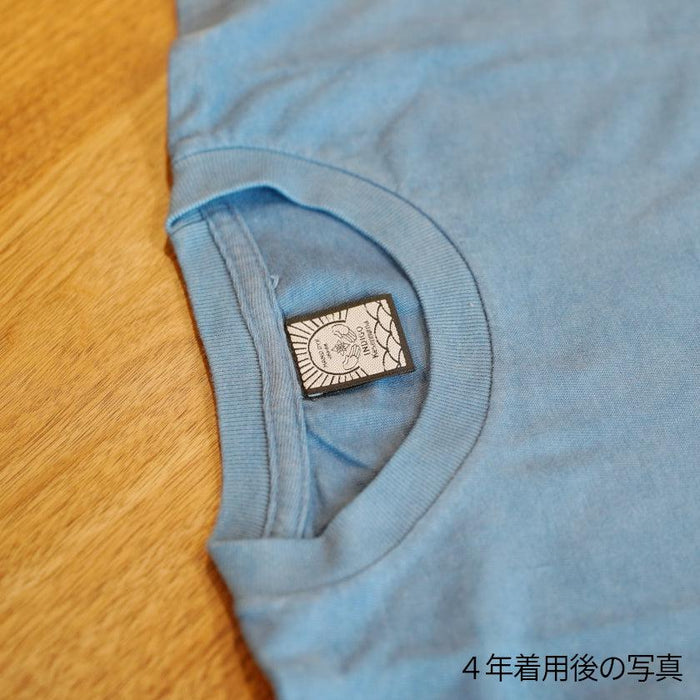 Light blue indigo-dyed T-shirt collar closeup showing woven brand label after 4 years of wear | Indigo Kesennuma