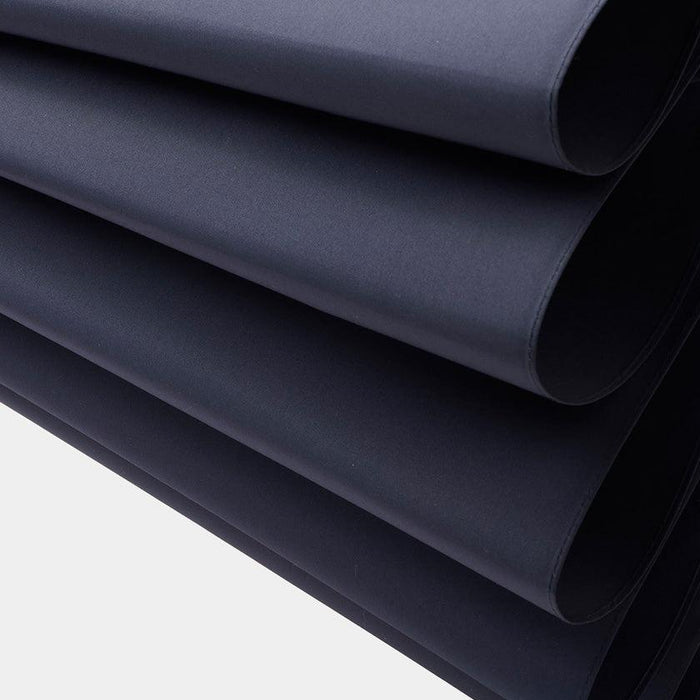 Stacked layers of navy blue fabric material used in Tokyo umbrella crafting | Maehara Koei Shoten